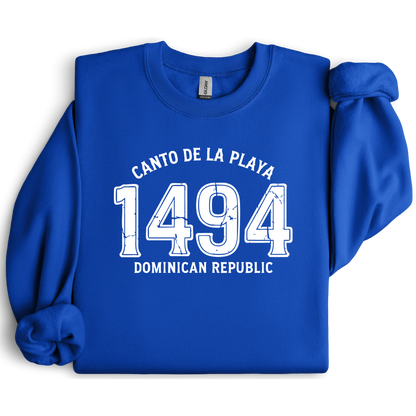 Gildan sweatshirt with “Canto De La Playa 1494 Dominican Republic” printed in distressed navy text. Vintage beach-inspired crewneck symbolizing Caribbean heritage and coastal charm. Made from soft cotton-poly blend fabric for comfort and style, ideal for beach lovers and travelers who adore Dominican culture. Cozy, sustainable, and perfect for casual wear or tropical getaways.