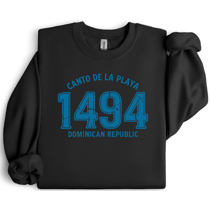 Gildan sweatshirt with “Canto De La Playa 1494 Dominican Republic” printed in distressed navy text. Vintage beach-inspired crewneck symbolizing Caribbean heritage and coastal charm. Made from soft cotton-poly blend fabric for comfort and style, ideal for beach lovers and travelers who adore Dominican culture. Cozy, sustainable, and perfect for casual wear or tropical getaways.