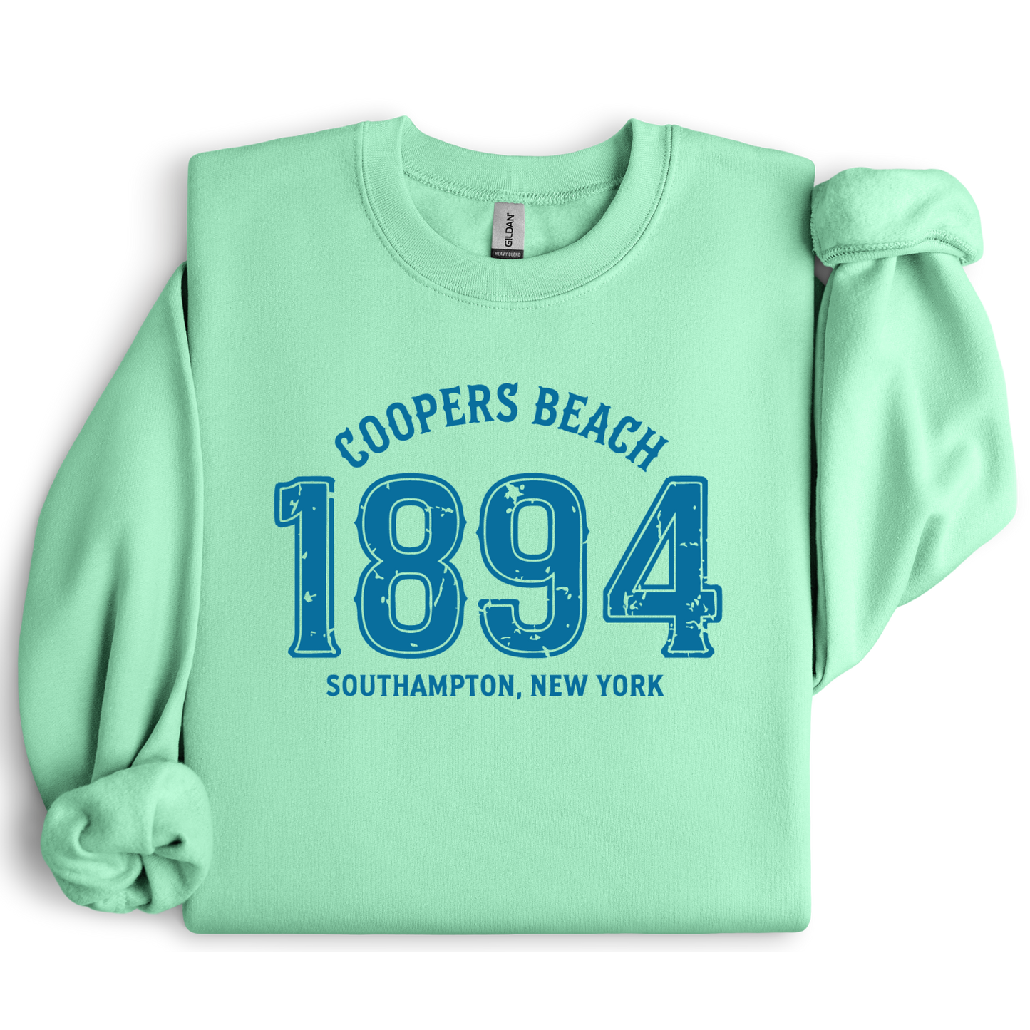 Mint green sweatshirt with blue text 'Coopers Beach 1894 Southampton, New York' on a white background