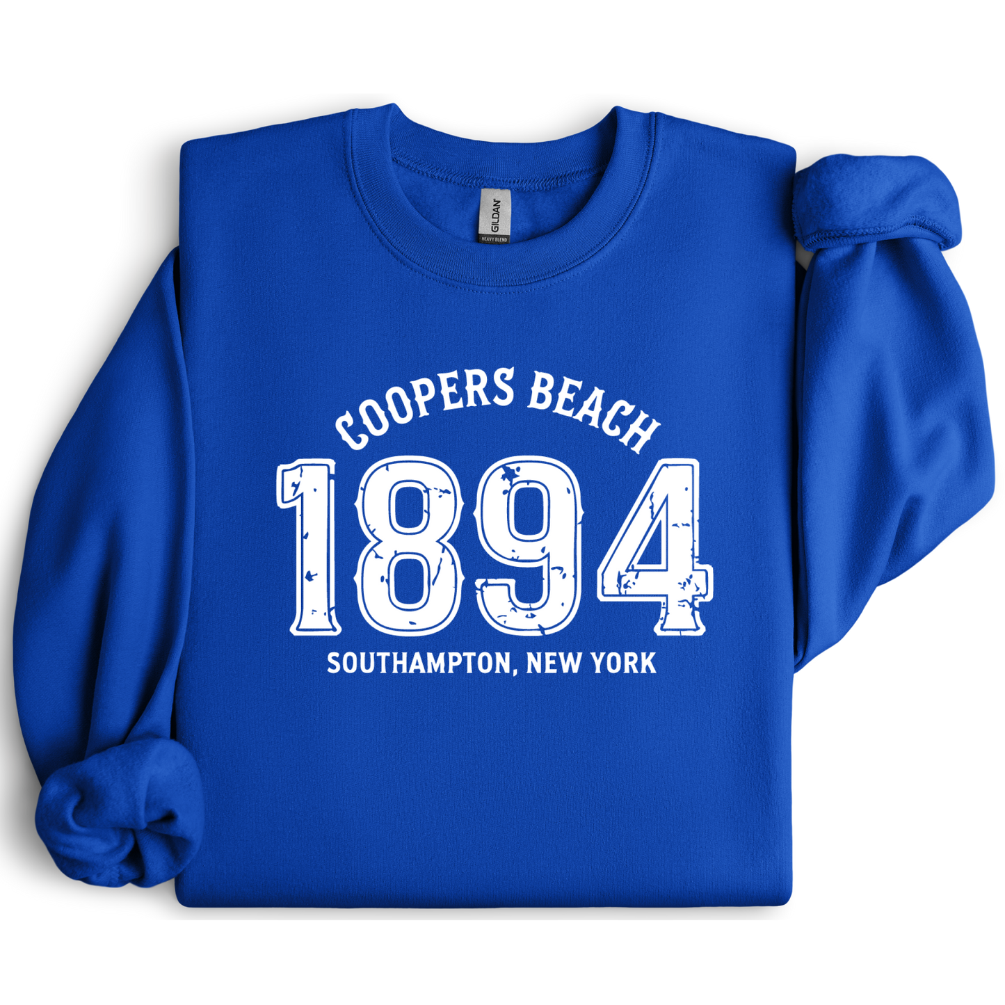 Blue sweatshirt with white text 'Coopers Beach 1894 Southampton, New York' on a white background