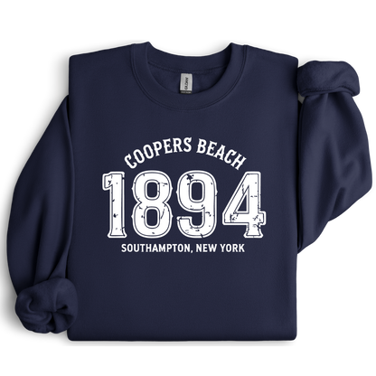 Navy blue sweatshirt with white text 'Coopers Beach 1894 Southampton, New York' on a white background
