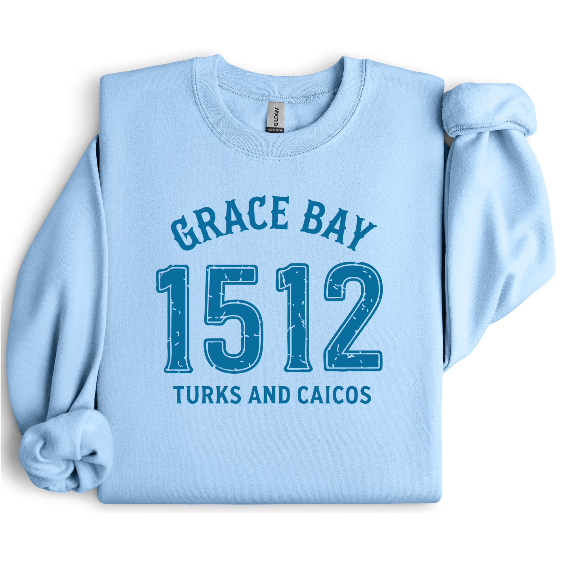 Gildan sweatshirt featuring blue text that reads “Grace Bay 1512 Turks and Caicos” in a vintage collegiate style. Cozy cotton-poly blend pullover with ribbed cuffs and waistband for a relaxed, durable fit. Ideal for beach lovers, island travelers, and fans of coastal fashion. Perfect for staying cozy while showcasing love for one of the Caribbean’s most beautiful beaches — Grace Bay.