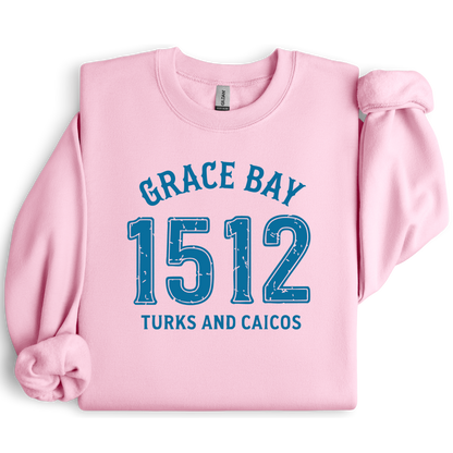 Gildan sweatshirt featuring blue text that reads “Grace Bay 1512 Turks and Caicos” in a vintage collegiate style. Cozy cotton-poly blend pullover with ribbed cuffs and waistband for a relaxed, durable fit. Ideal for beach lovers, island travelers, and fans of coastal fashion. Perfect for staying cozy while showcasing love for one of the Caribbean’s most beautiful beaches — Grace Bay.