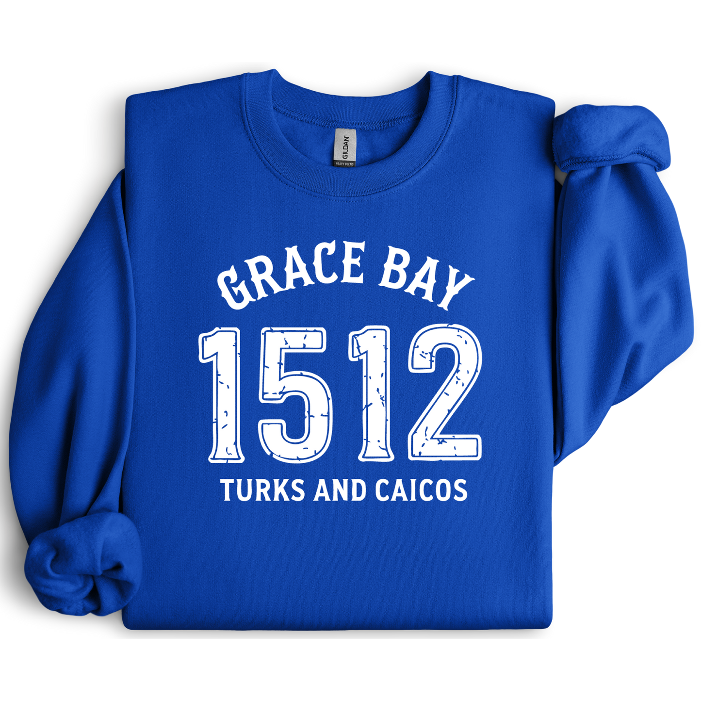 Gildan sweatshirt featuring blue text that reads “Grace Bay 1512 Turks and Caicos” in a vintage collegiate style. Cozy cotton-poly blend pullover with ribbed cuffs and waistband for a relaxed, durable fit. Ideal for beach lovers, island travelers, and fans of coastal fashion. Perfect for staying cozy while showcasing love for one of the Caribbean’s most beautiful beaches — Grace Bay.