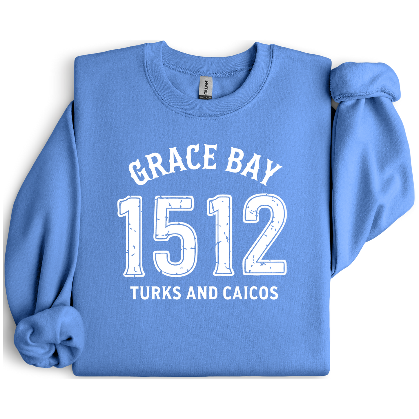 Gildan sweatshirt featuring blue text that reads “Grace Bay 1512 Turks and Caicos” in a vintage collegiate style. Cozy cotton-poly blend pullover with ribbed cuffs and waistband for a relaxed, durable fit. Ideal for beach lovers, island travelers, and fans of coastal fashion. Perfect for staying cozy while showcasing love for one of the Caribbean’s most beautiful beaches — Grace Bay.