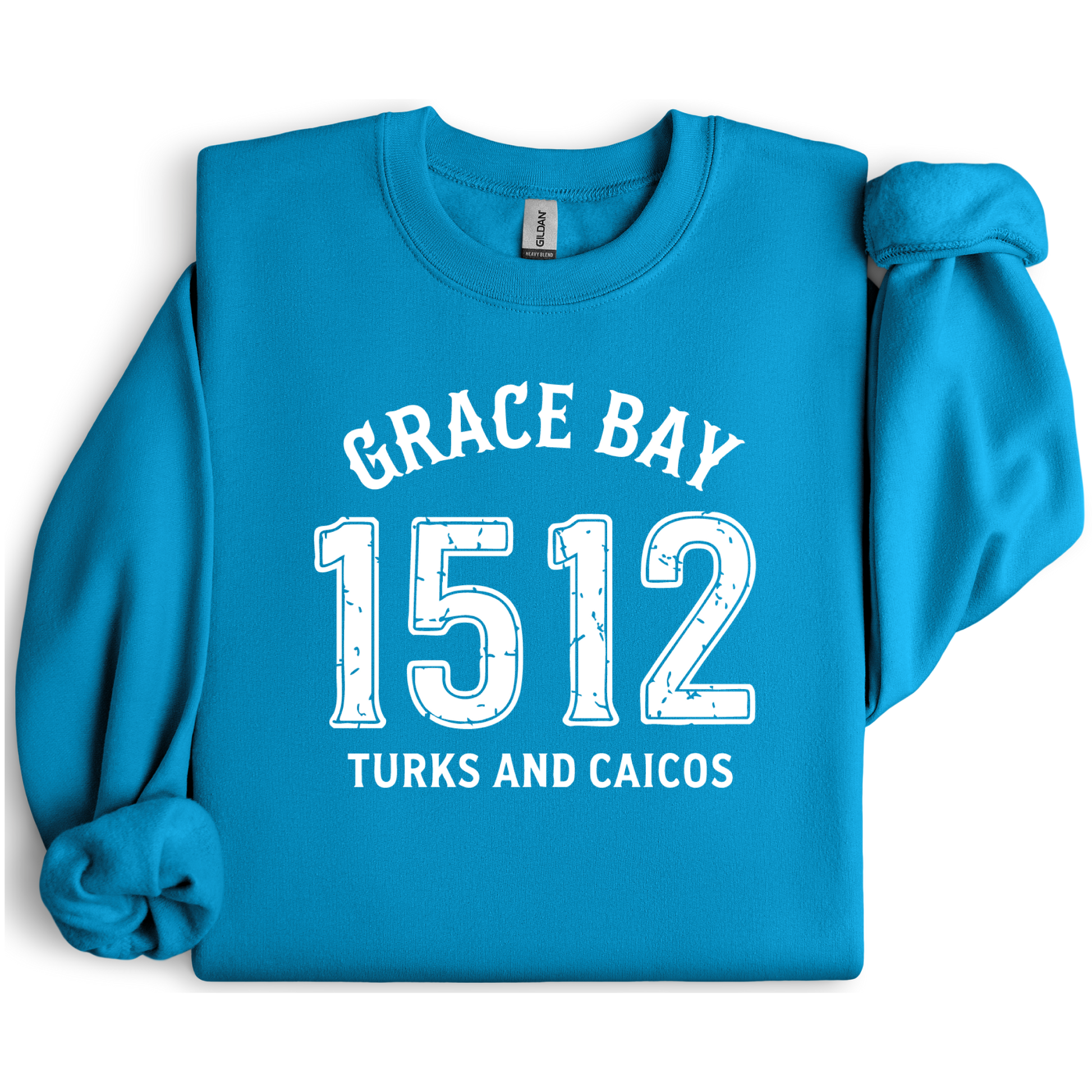 Gildan sweatshirt featuring blue text that reads “Grace Bay 1512 Turks and Caicos” in a vintage collegiate style. Cozy cotton-poly blend pullover with ribbed cuffs and waistband for a relaxed, durable fit. Ideal for beach lovers, island travelers, and fans of coastal fashion. Perfect for staying cozy while showcasing love for one of the Caribbean’s most beautiful beaches — Grace Bay.