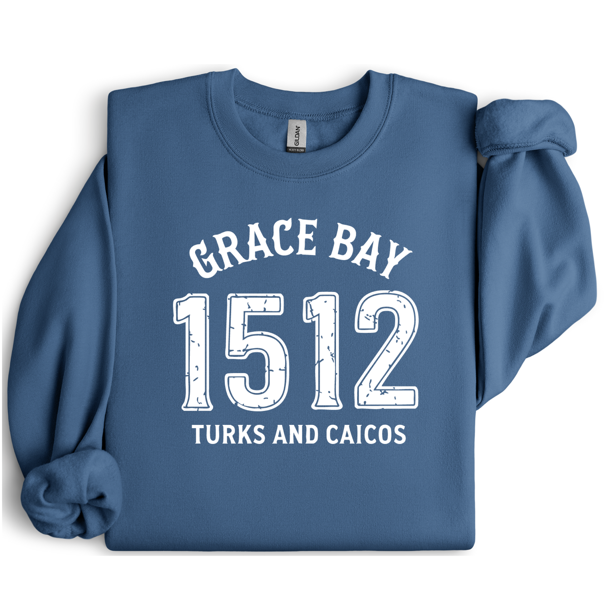 Gildan sweatshirt featuring blue text that reads “Grace Bay 1512 Turks and Caicos” in a vintage collegiate style. Cozy cotton-poly blend pullover with ribbed cuffs and waistband for a relaxed, durable fit. Ideal for beach lovers, island travelers, and fans of coastal fashion. Perfect for staying cozy while showcasing love for one of the Caribbean’s most beautiful beaches — Grace Bay.
