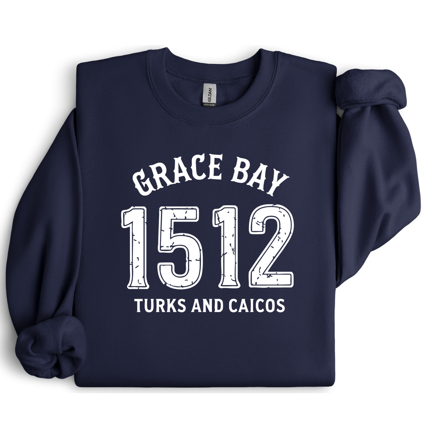 Gildan sweatshirt featuring blue text that reads “Grace Bay 1512 Turks and Caicos” in a vintage collegiate style. Cozy cotton-poly blend pullover with ribbed cuffs and waistband for a relaxed, durable fit. Ideal for beach lovers, island travelers, and fans of coastal fashion. Perfect for staying cozy while showcasing love for one of the Caribbean’s most beautiful beaches — Grace Bay.