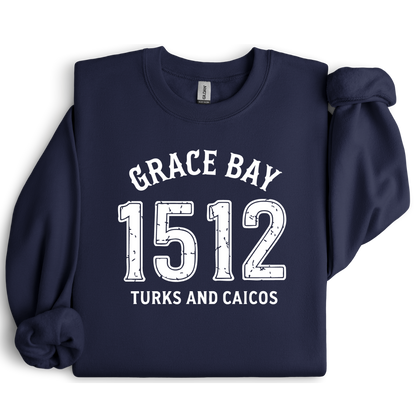 Gildan sweatshirt featuring blue text that reads “Grace Bay 1512 Turks and Caicos” in a vintage collegiate style. Cozy cotton-poly blend pullover with ribbed cuffs and waistband for a relaxed, durable fit. Ideal for beach lovers, island travelers, and fans of coastal fashion. Perfect for staying cozy while showcasing love for one of the Caribbean’s most beautiful beaches — Grace Bay.
