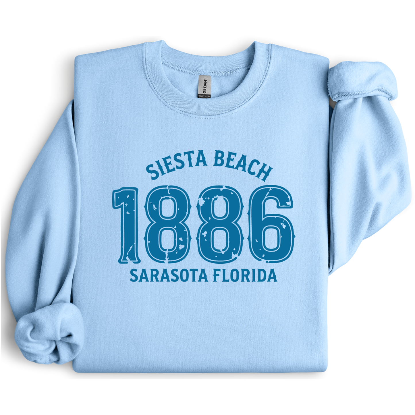 Light blue sweatshirt with 'Siesta Beach 1886 Sarasota Florida' text on a white background