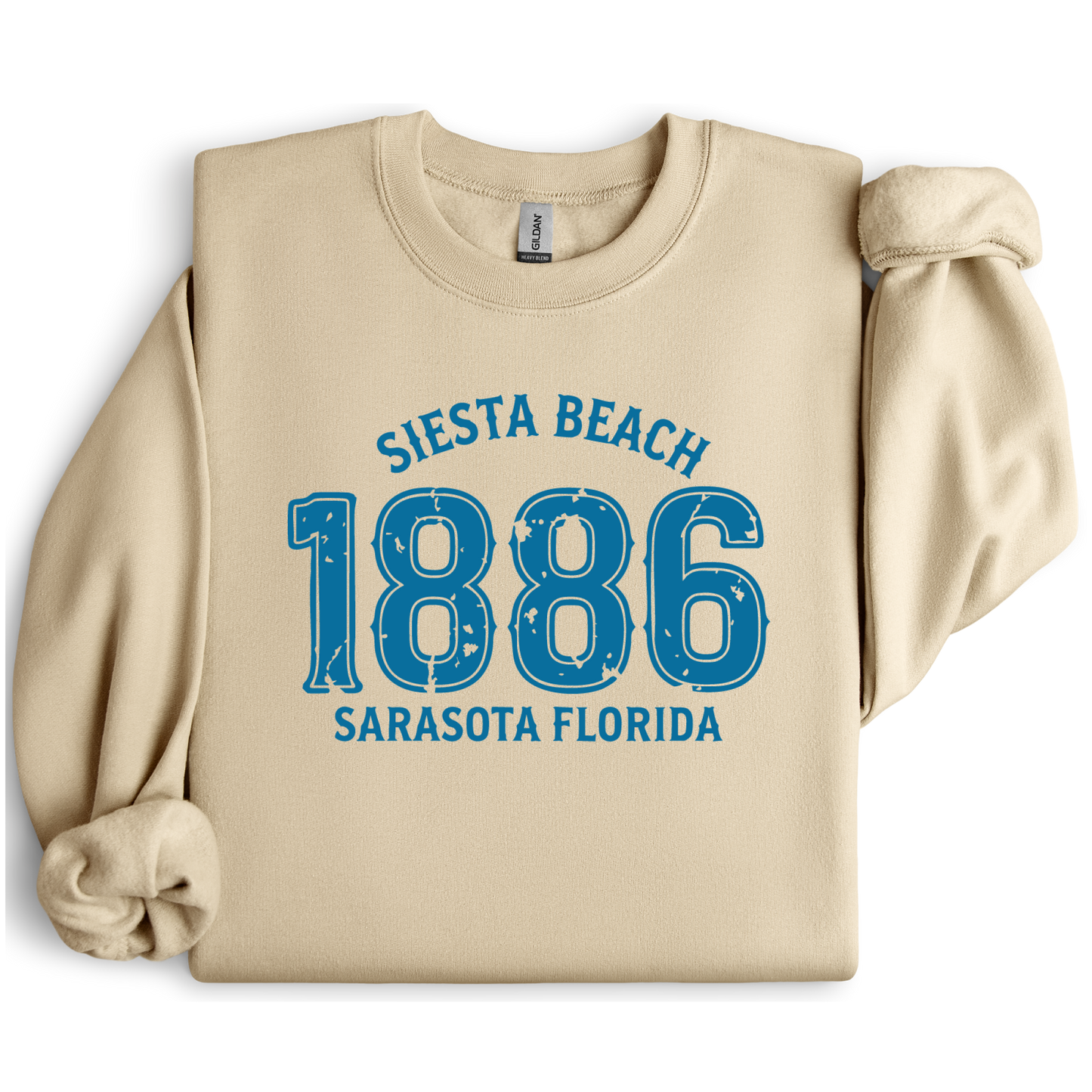 Sand sweatshirt with blue text 'Siesta Beach 1886 Sarasota Florida' on a white background