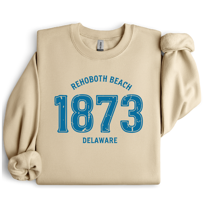 Sand  sweatshirt with blue text 'Rehoboth Beach 1873 Delaware' on a white background
