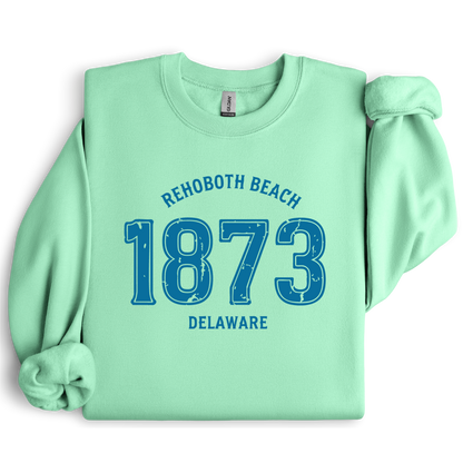 Mint green sweatshirt with blue text 'Rehoboth Beach 1873 Delaware' on a white background