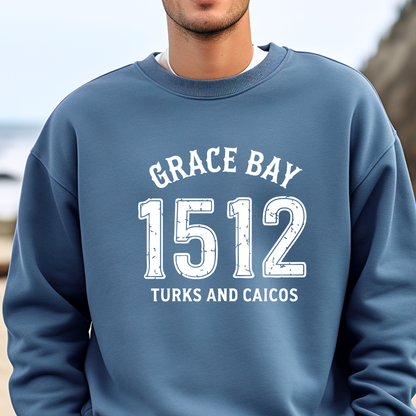 Gildan sweatshirt featuring blue text that reads “Grace Bay 1512 Turks and Caicos” in a vintage collegiate style. Cozy cotton-poly blend pullover with ribbed cuffs and waistband for a relaxed, durable fit. Ideal for beach lovers, island travelers, and fans of coastal fashion. Perfect for staying cozy while showcasing love for one of the Caribbean’s most beautiful beaches — Grace Bay.