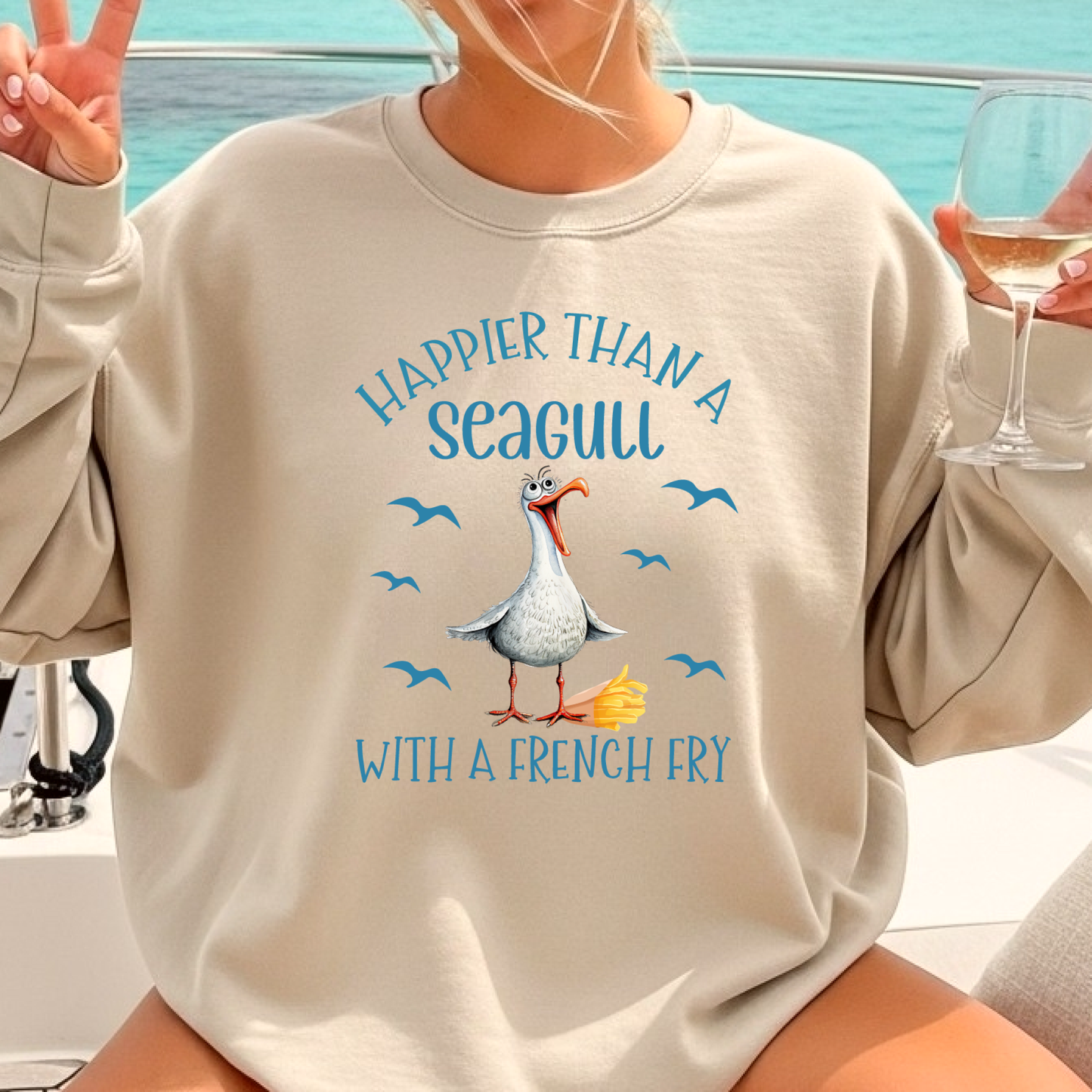 Person wearing a beige sweatshirt with a seagull graphic and text, sitting on a boat.